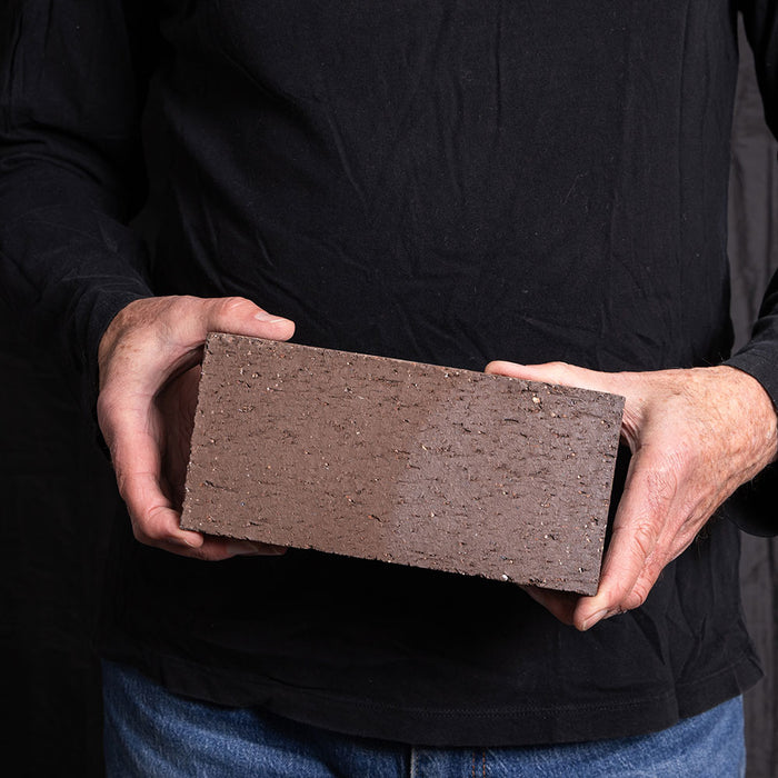 A Catalina brick paver in Brown Flashed held in a hand