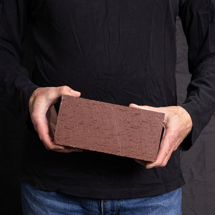 A Catalina brick paver in Burgundy held in a hand
