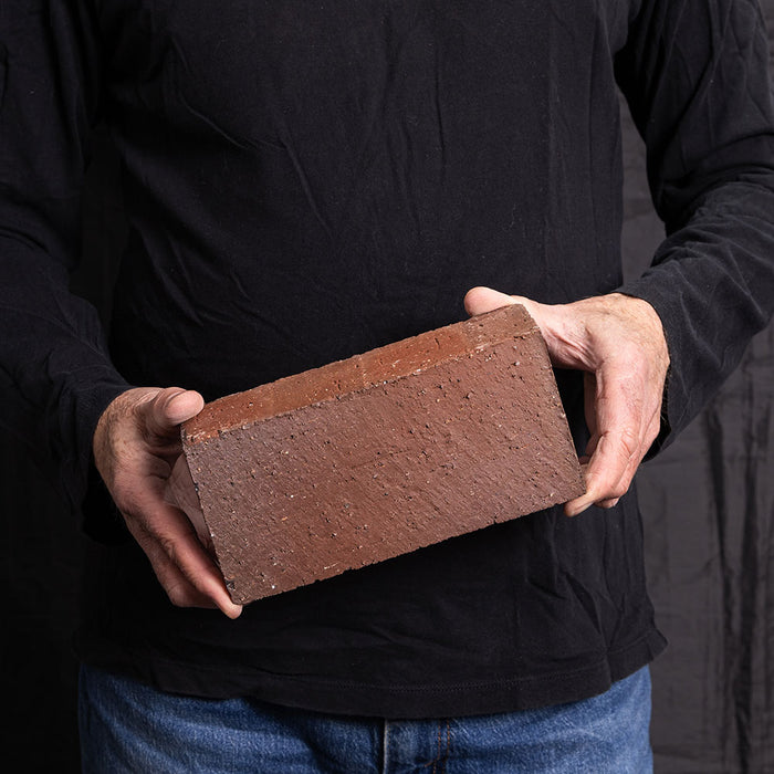 A Catalina brick paver in Red Flashed held in a hand