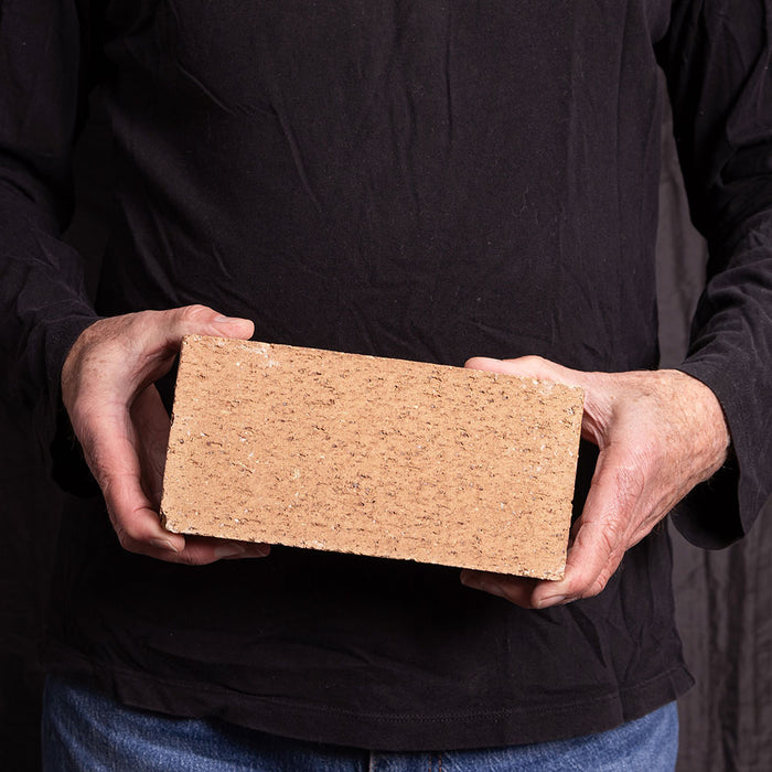 A Catalina brick paver in Saltillo held in a hand
