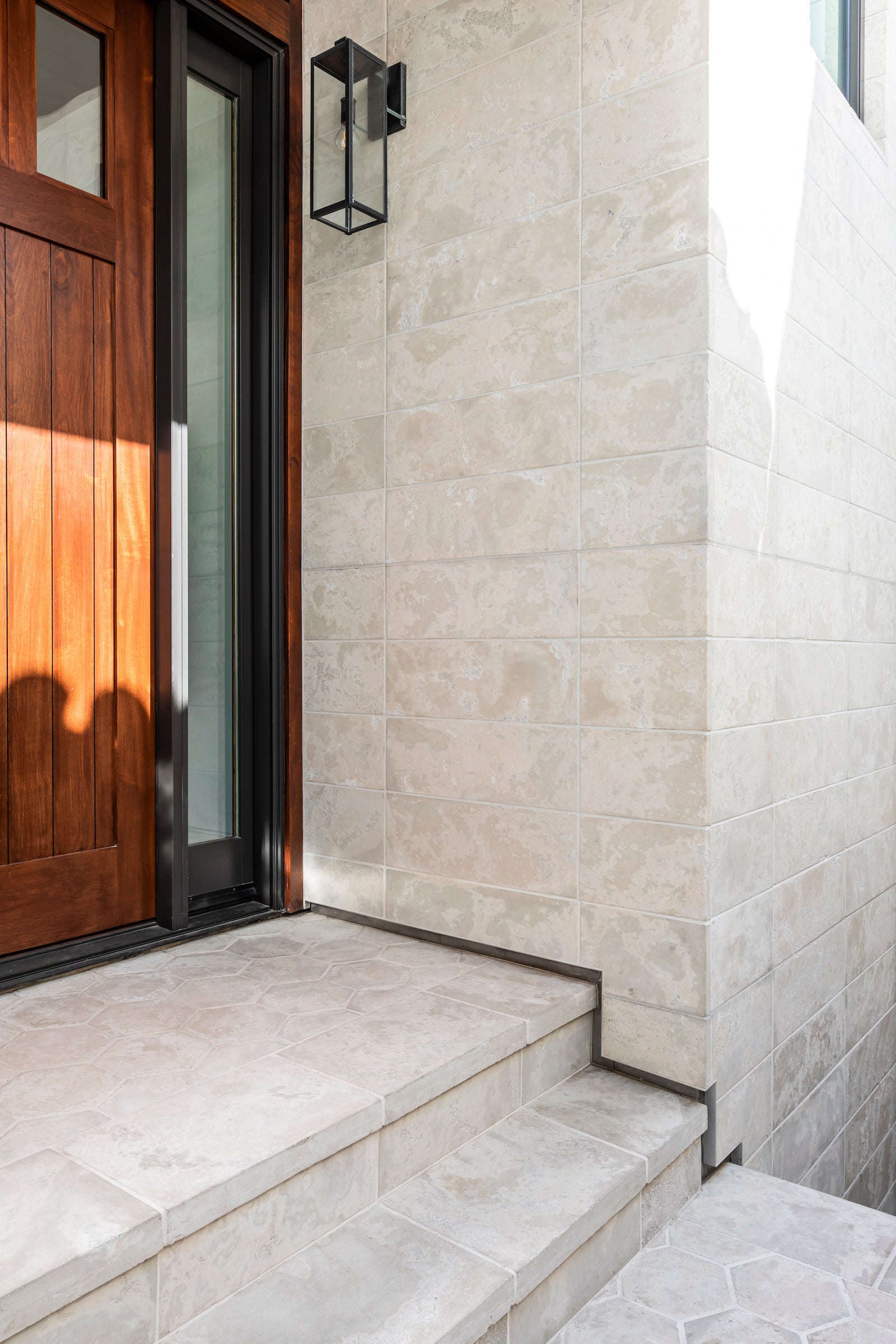 The Strand house wall in 18 inch Roman tile, Early Gray color, Limestone texture