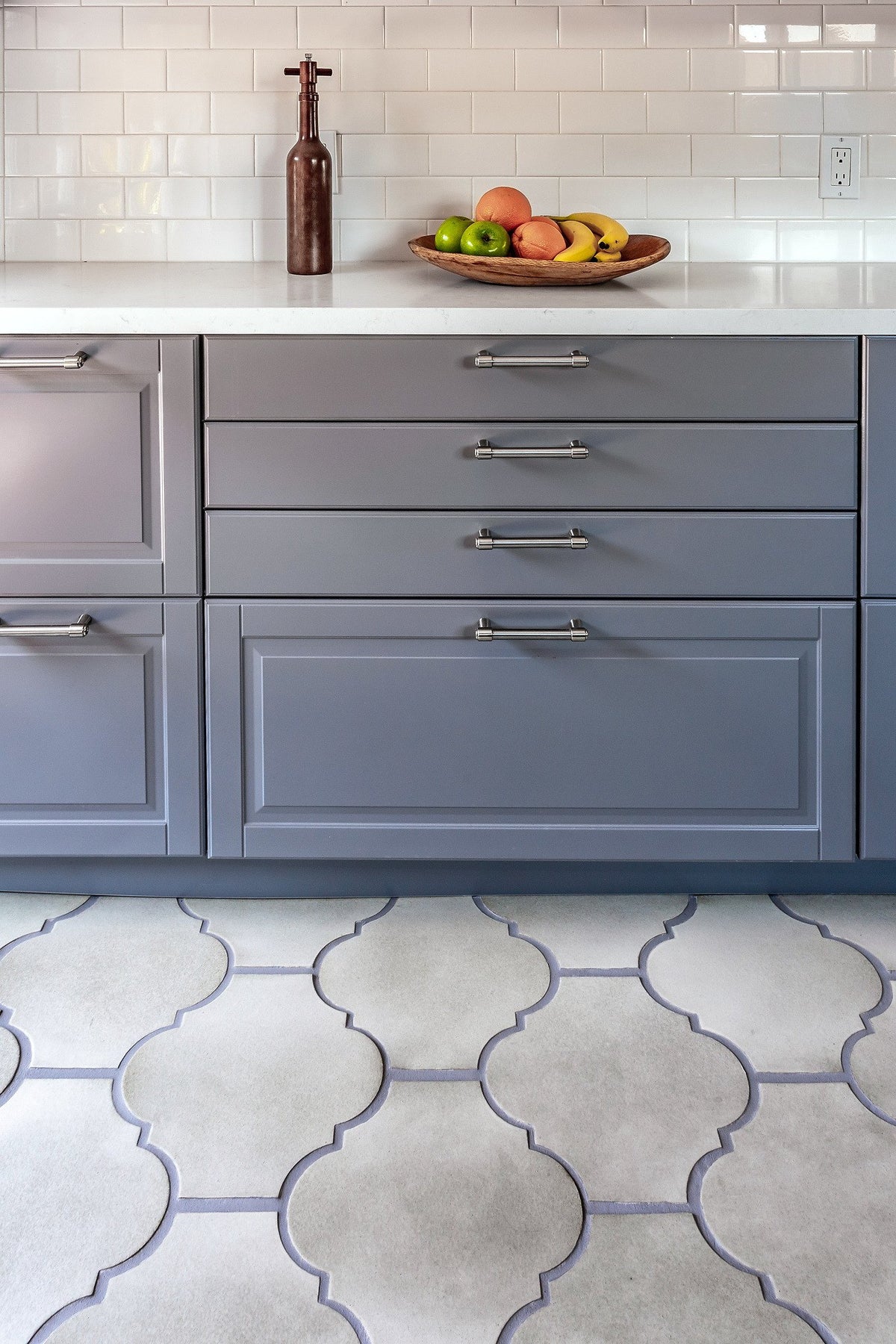 Cabinet run over scalloped tile