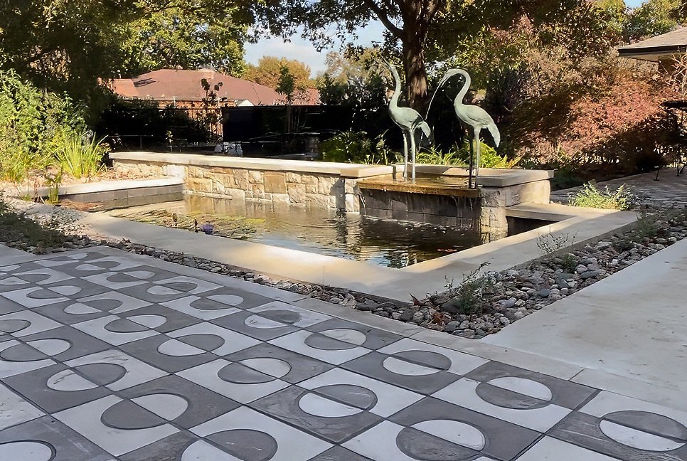 Arch pattern tile patio by the pond