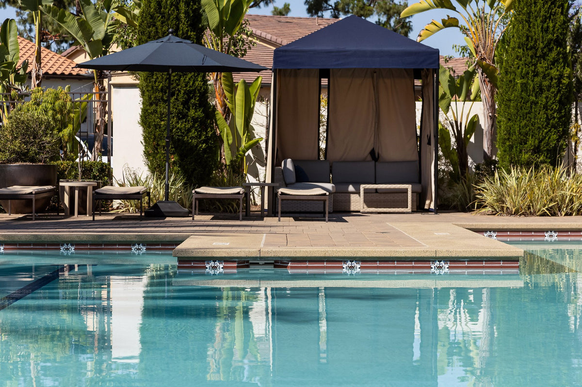 Pool and cabanas with tiled waterline