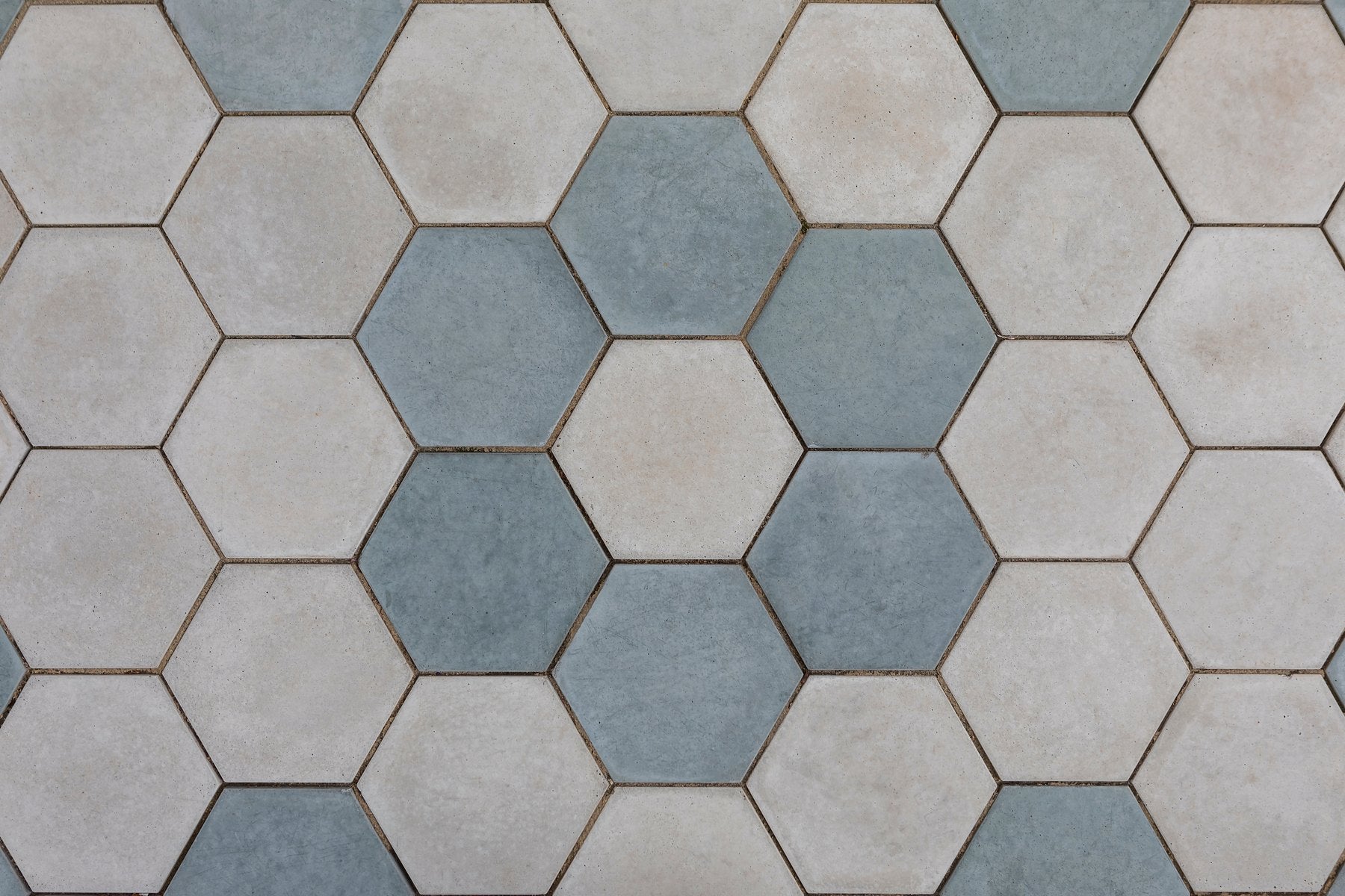 Eight inch hexagon pavers seen from above, two colors laid in a scattered pattern