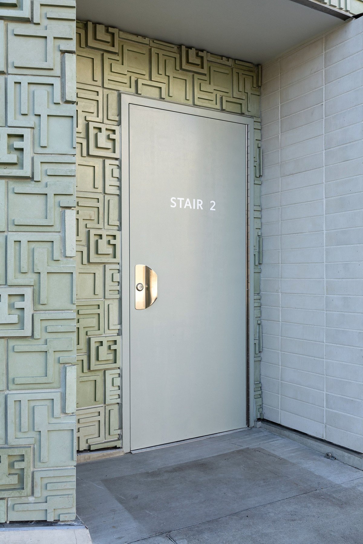 Stair door framed by relief tile