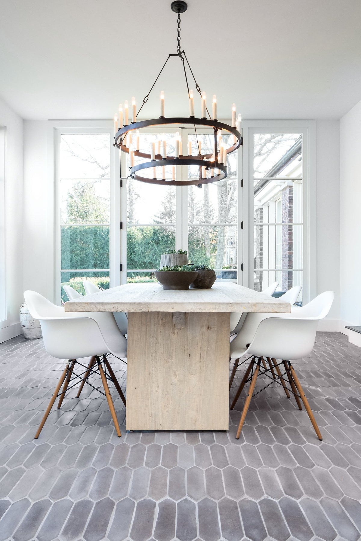 Table and chandelier over Picket tile
