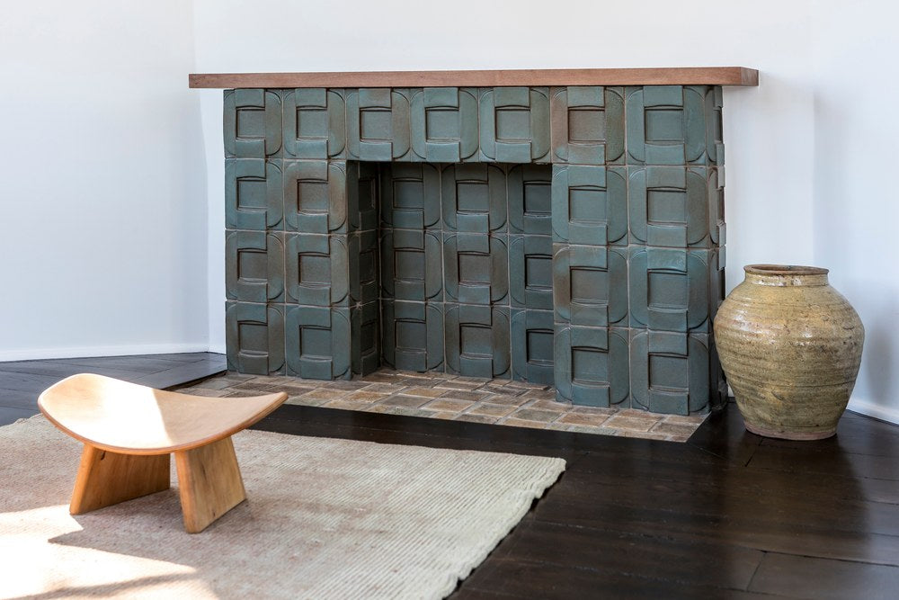 A whole fireplace surround built in the Buckle pattern, Elder Green glaze, at Whitley Heights