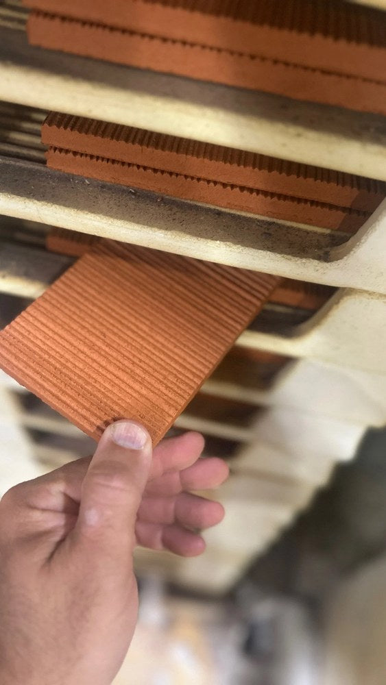 Raw Corduroy tiles on the kiln rack before glazing, the flutes extruded into the clay body