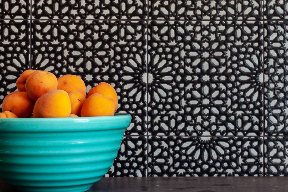 A Kaleidoscope design run as a kitchen backsplash in black and white