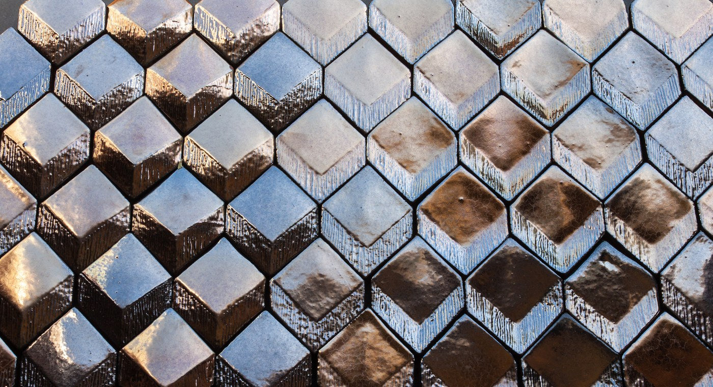RR Collection diamonds laid together, the flat, convex and concave faces reading as one pattern in a metallic glaze