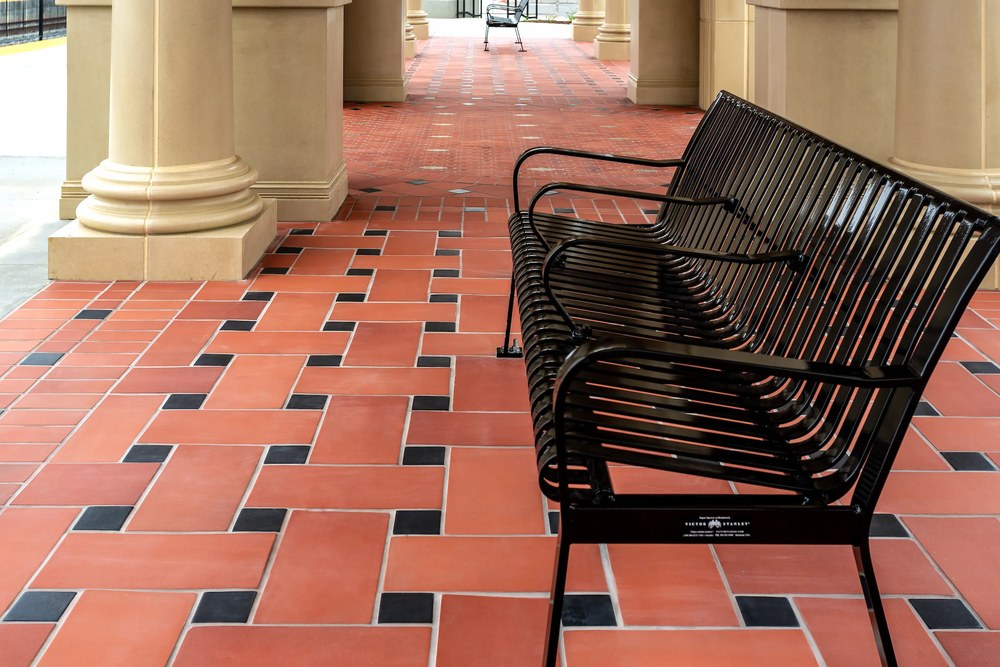 Monrovia and Studio pavers under a colonnade at the University of Redlands train station, with Black Diamond inserts