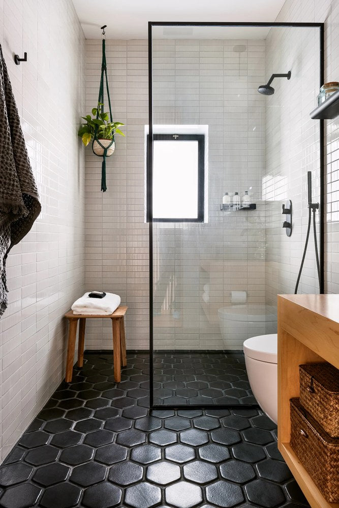 Oleson 6 inch hexagon in Abyss on a bathroom floor