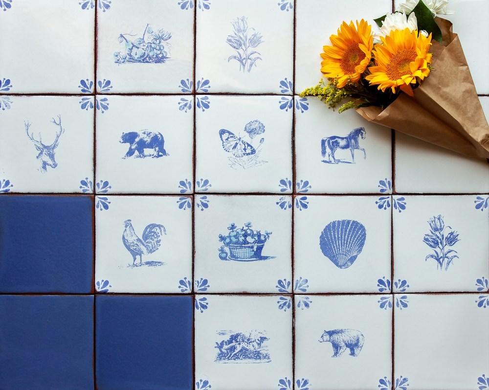 Peninsula decos laid out together, the deer, the bear, the butterfly, the horse, the rooster, the shell and the tulips, with solid Blue Satin among them