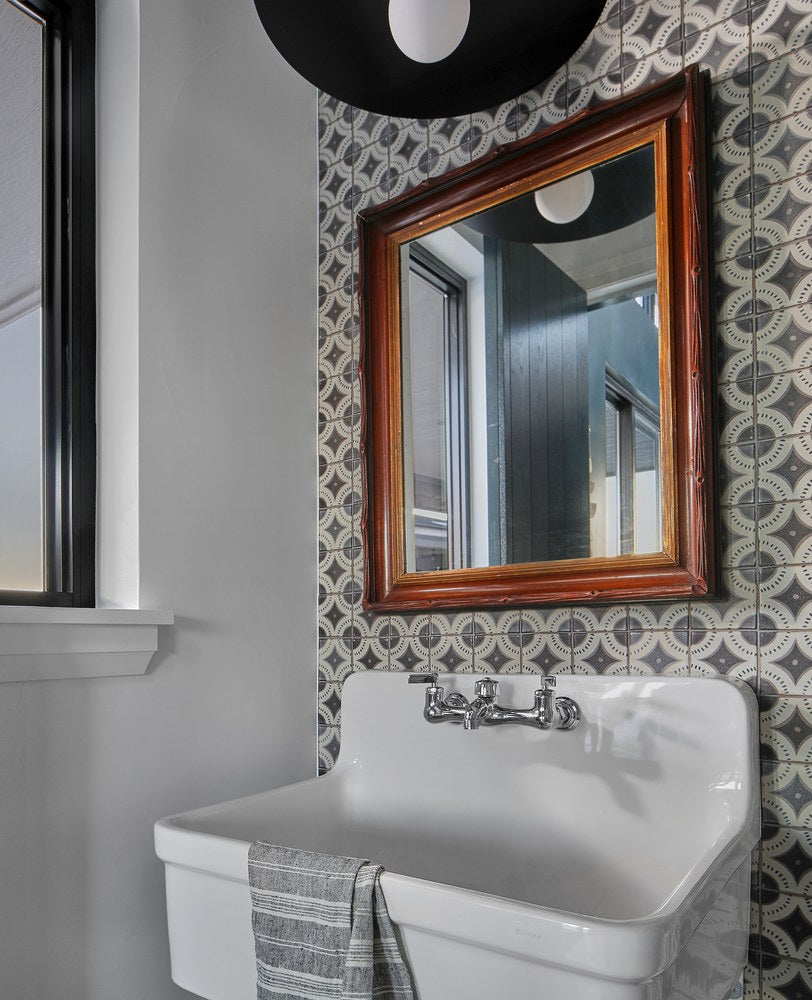 Scirocco 4x4 decos covering a powder room wall behind a vintage sink