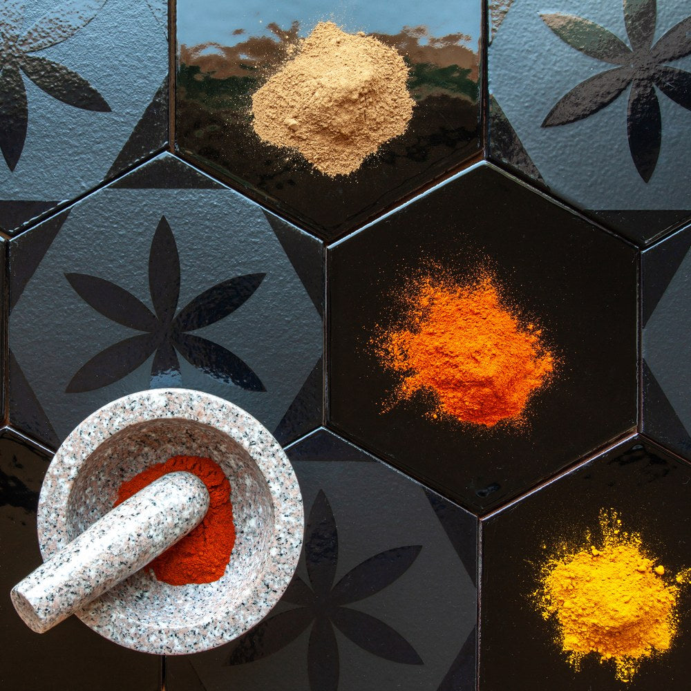 Ground spices set out on a Silk Road hexagon, one tile filling the frame