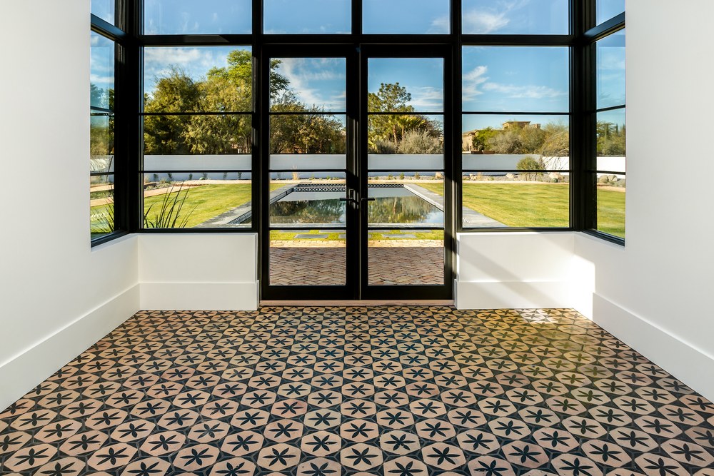 The same floor running to a wall of doors, the pattern reading right across the room