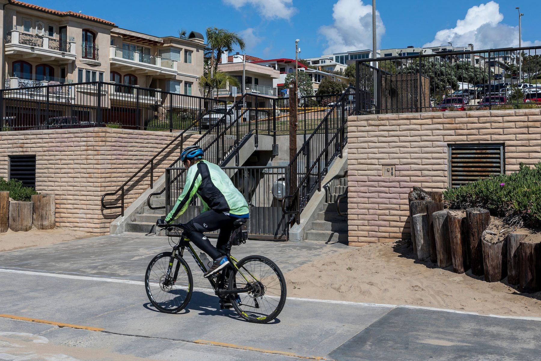 Adobe Brick in a custom color on the Manhattan Beach pumping station, a cyclist passing for scale