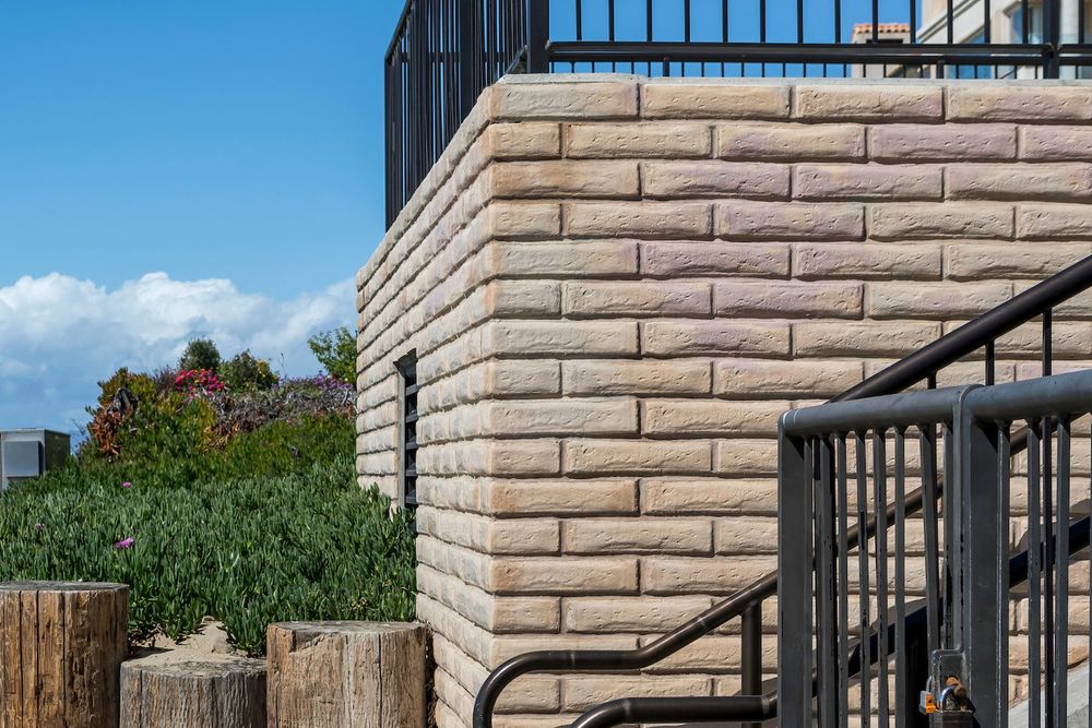 Adobe Brick in a custom color turning the corner of the Manhattan Beach pumping station, beach path beyond