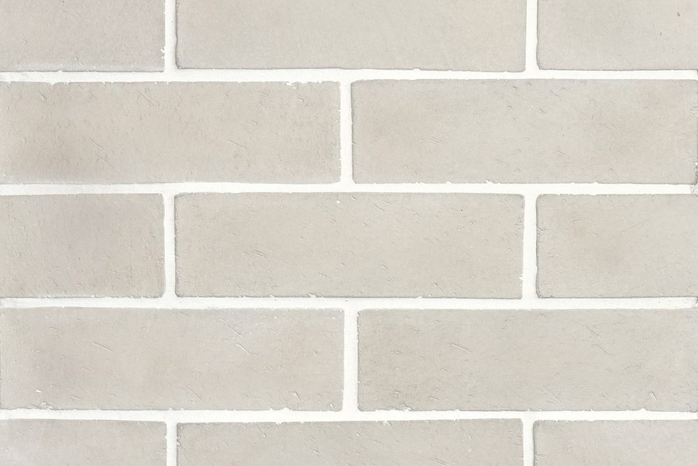 Norman Brick in 3 by 11 Early Gray, running bond field with white grout
