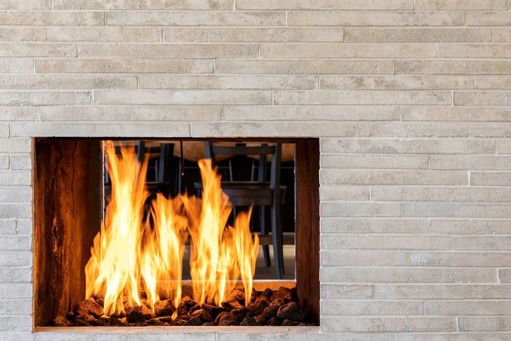 Newport Brick Veneer in 2 by 20 Early Gray around a Corona del Mar fireplace