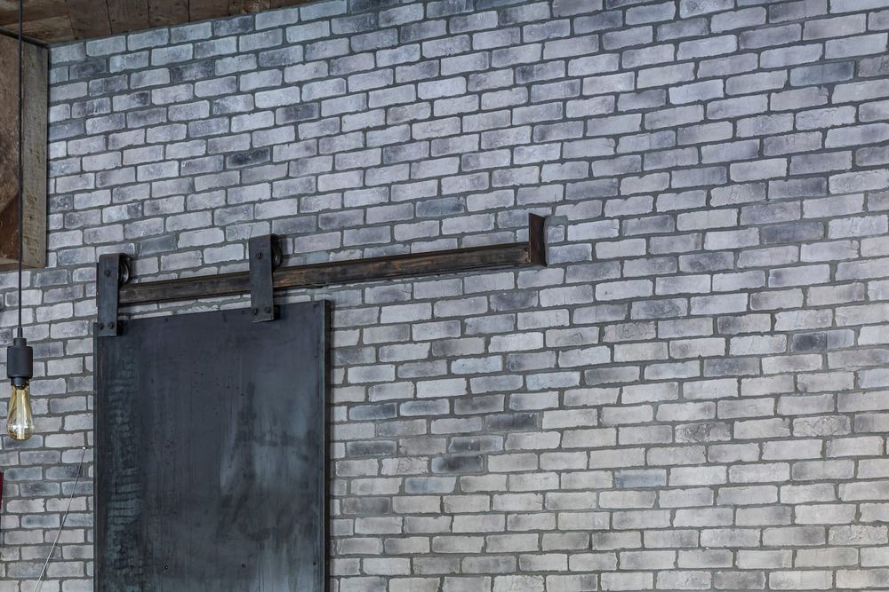 Bastogne Brick Veneer in Antik Gray behind a steel sliding door at Satellite SB