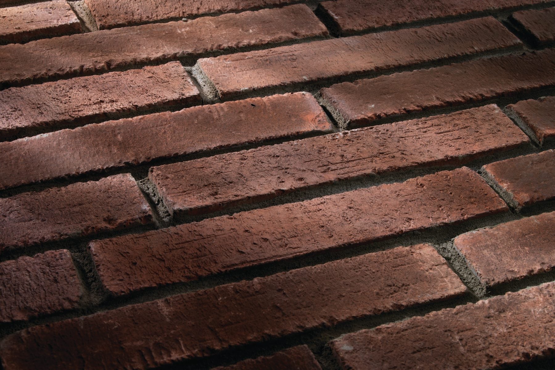 University Brick Veneer in 2 by 11 Red Flash, wire cut face in raking light