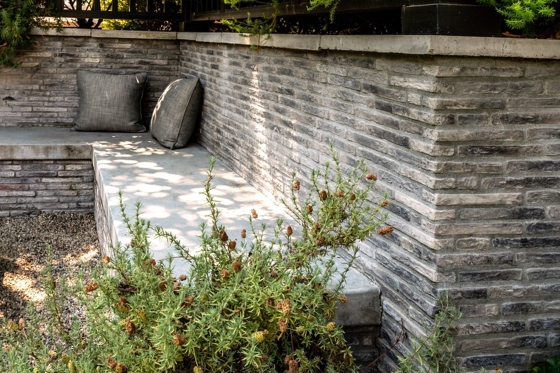Villagio Brick in gray on garden walls in Encino, narrow coursing wrapping a corner beside a built in bench