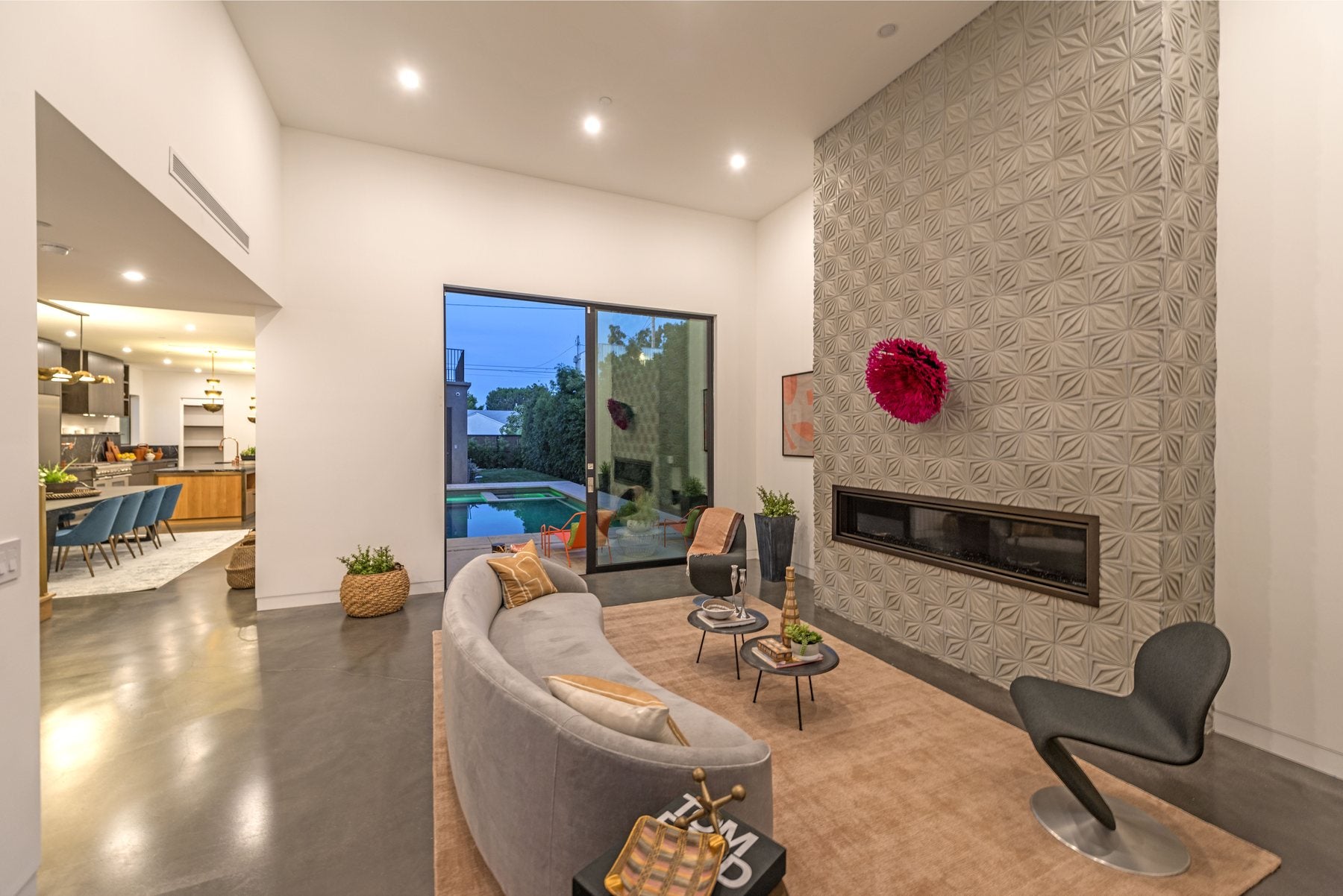 A full height Compass Star concrete wall around a linear fireplace in a living room