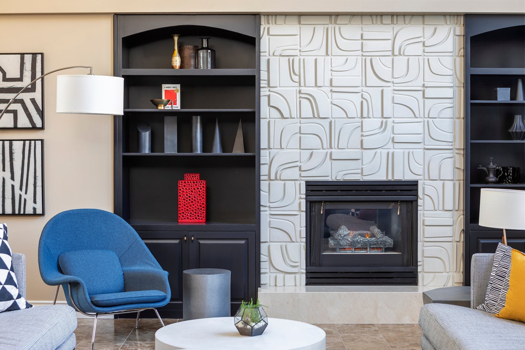 An M3LD Brute fireplace surround in Early Gray between two black bookcases