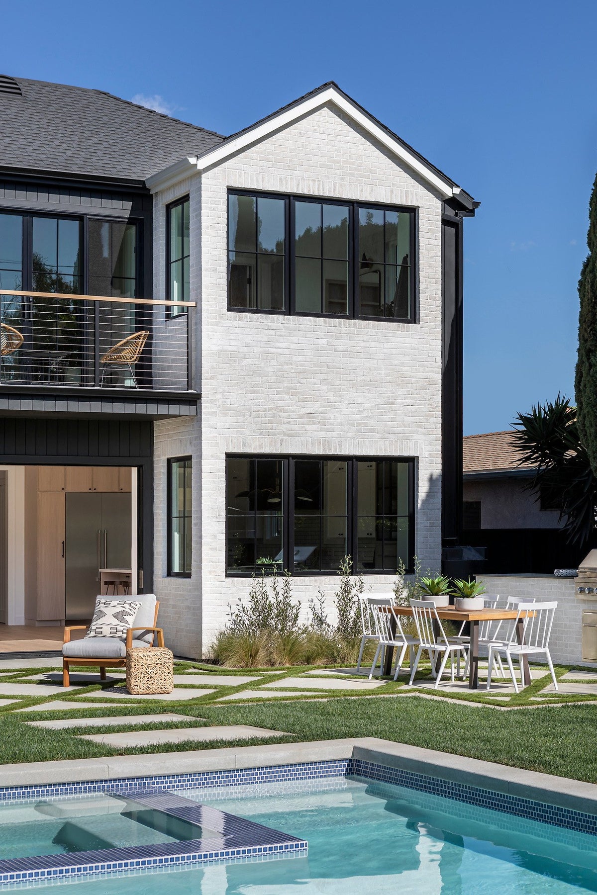 Two-story brick wall over the pool