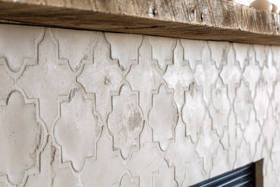 A fireplace faced in ARTO Artillo Arabesque in Early Gray