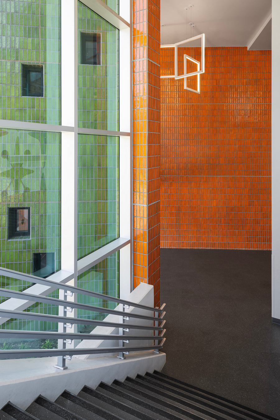 The stair at Belle Isle Library, green glazed brick outside the glass and orange glazed brick inside it