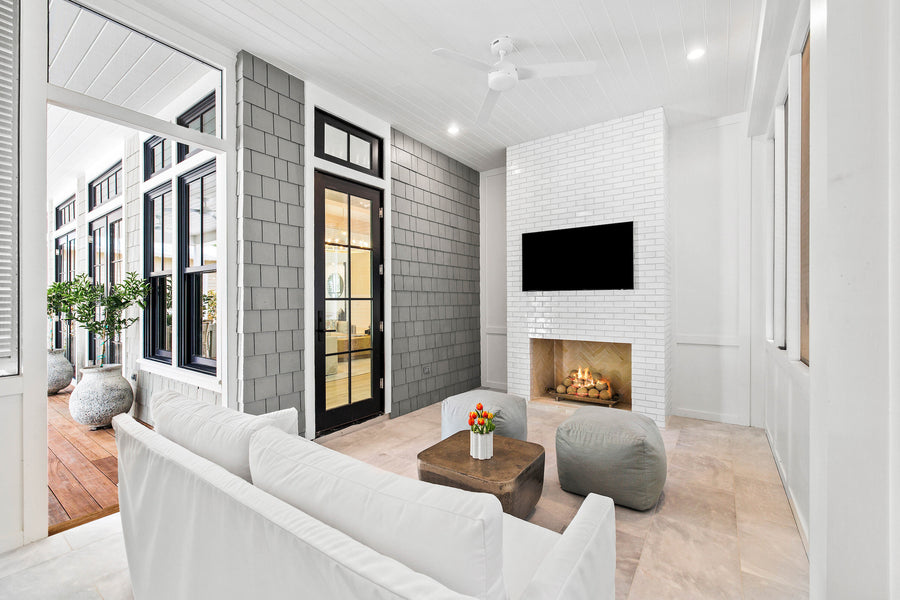 A fireplace of glazed brick in Pure White on a covered porch, running bond, floor to ceiling