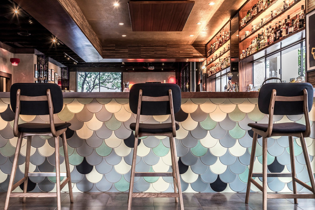 Bar stools against Conche bar front