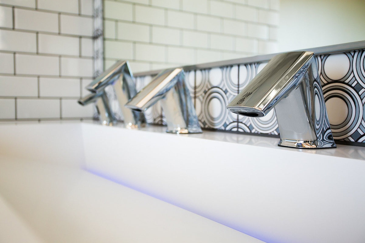 Faucets against the deco backsplash