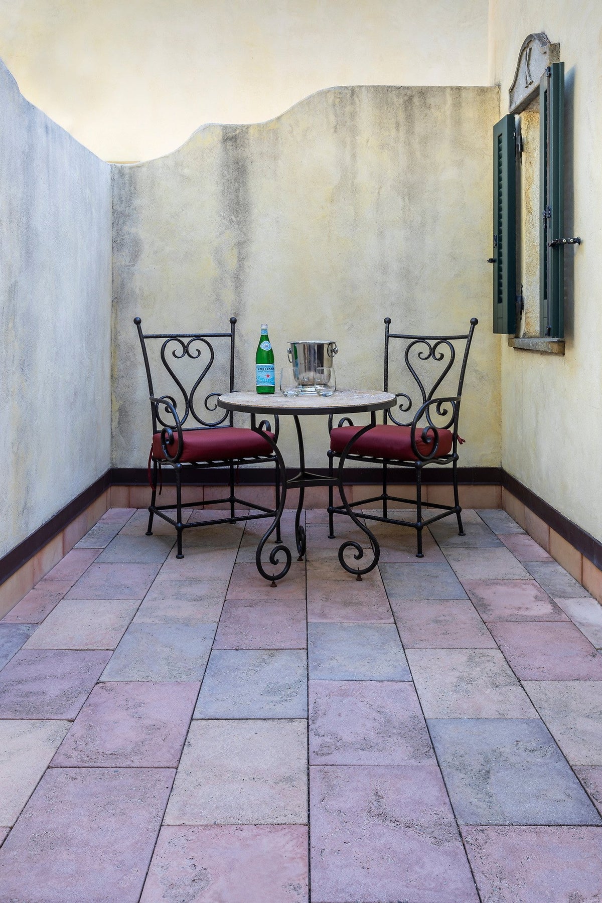 Courtyard terrace with wrought iron chairs