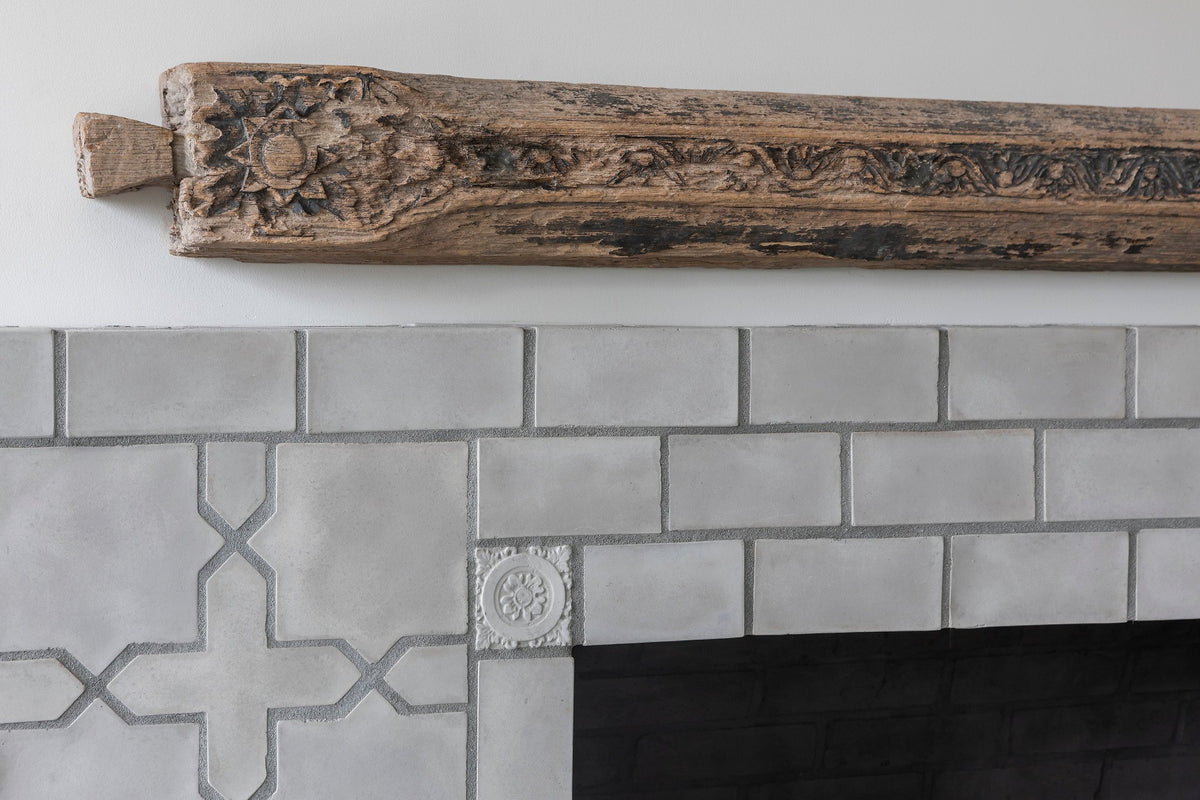 Surround tiles below the carved mantel