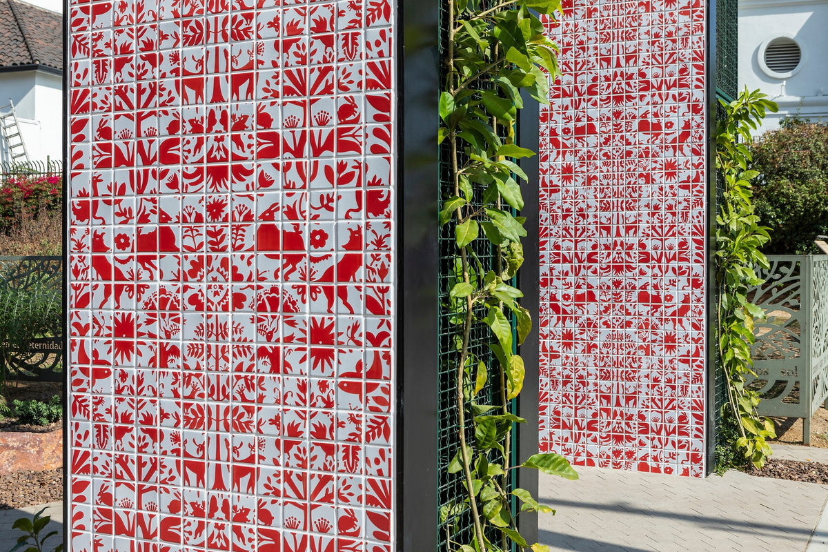 Red folk motifs on white tile