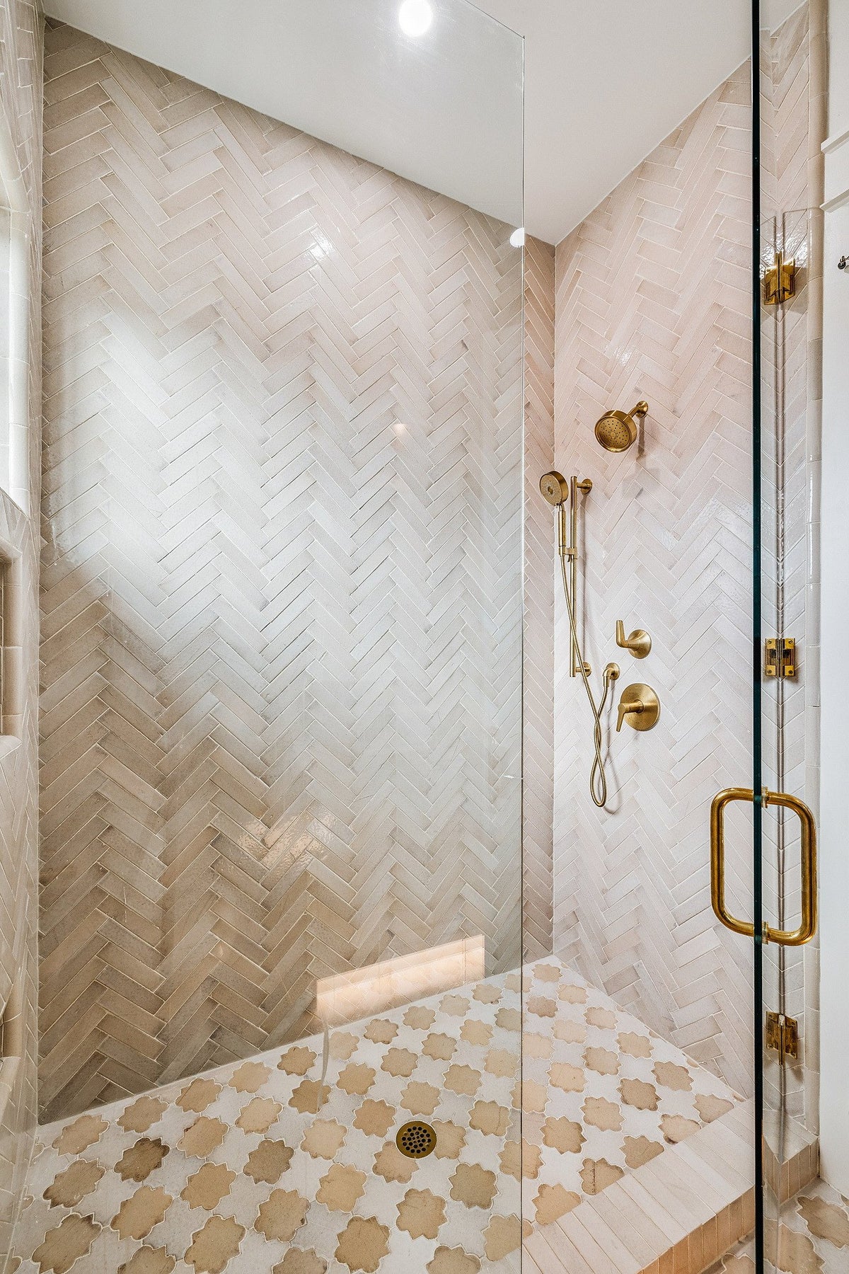 Herringbone shower over a patterned floor