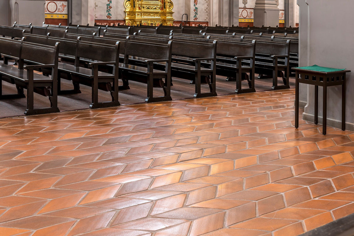 Chevron floor running under the pews