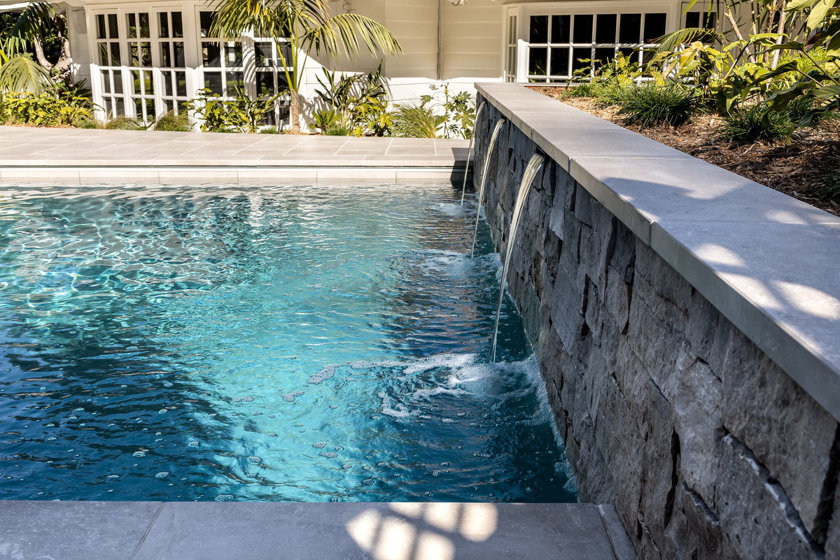 Stone water wall and pool edge