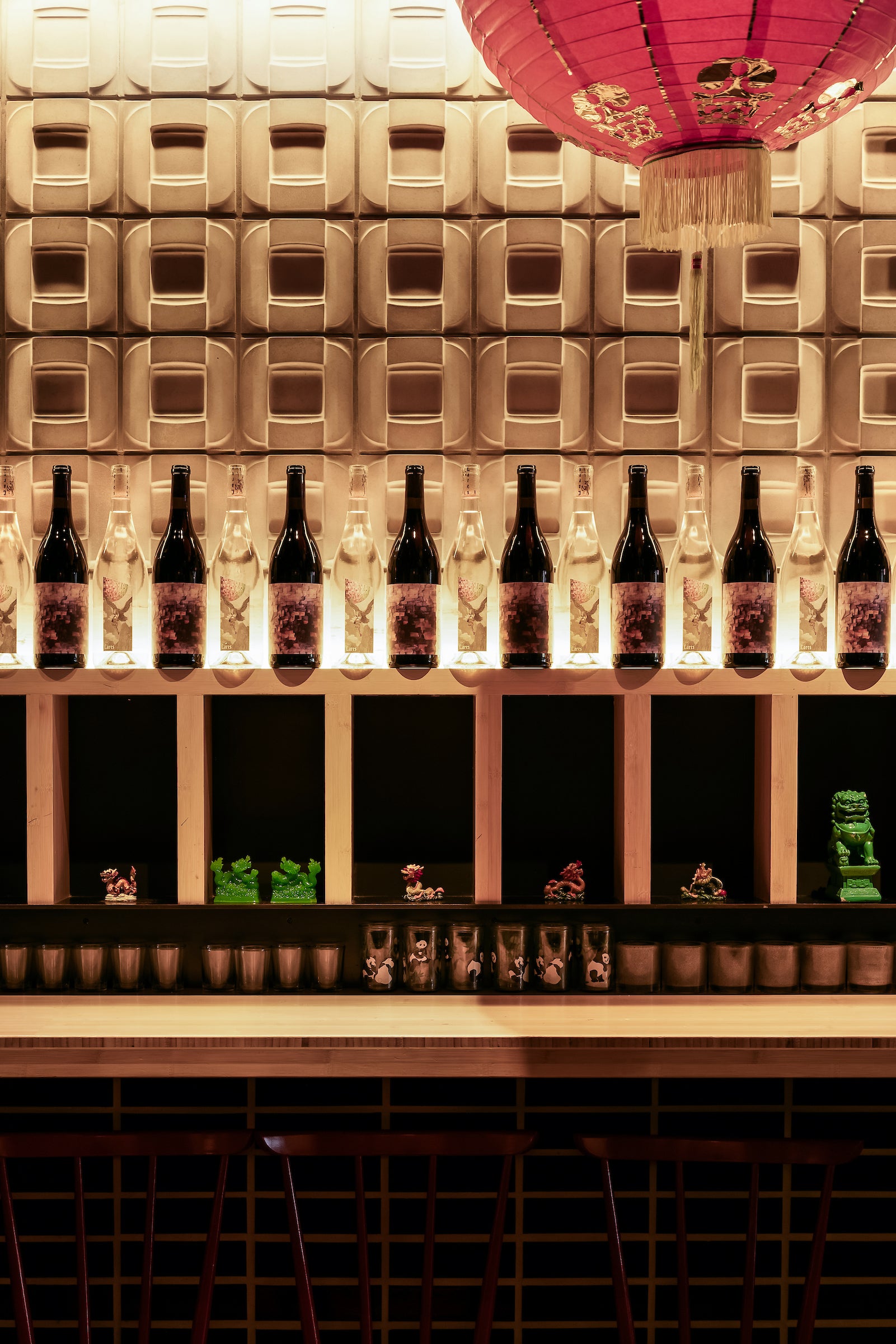 Buckle 6x6 concrete wall panels behind a lit wine display at Pinch, New York