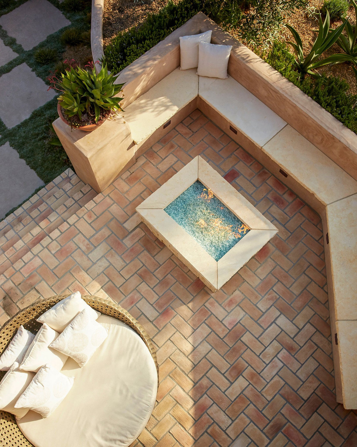Fire table framed by herringbone brick