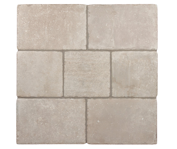 A board of Italian Porcelain tiles in Crema, mixed sizes laid together, a travertine cream, seen from above