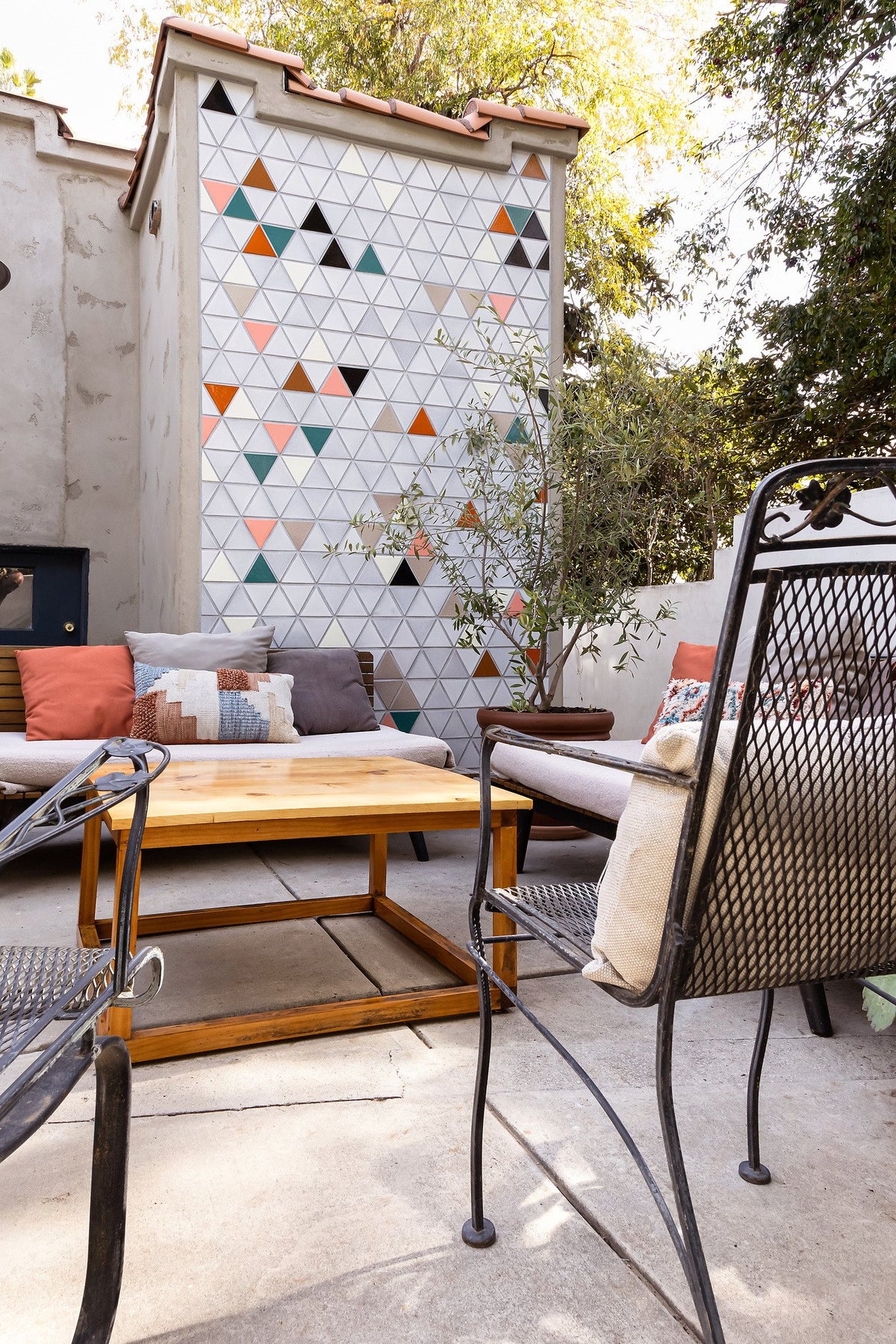 Patio seating facing the tile wall