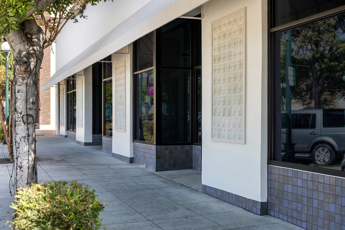 Sidewalk view of tiled facade