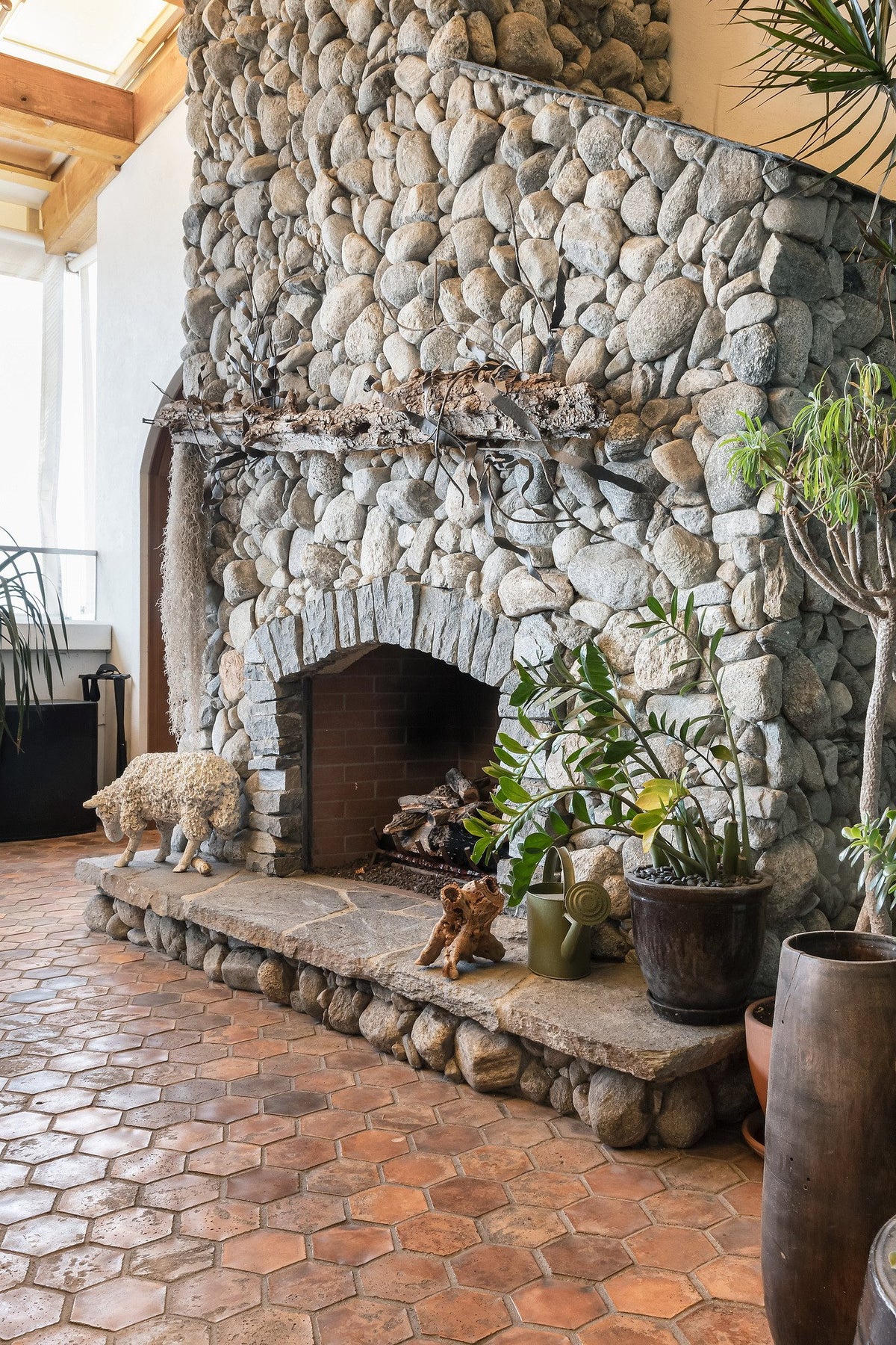 River rock fireplace on hex tile