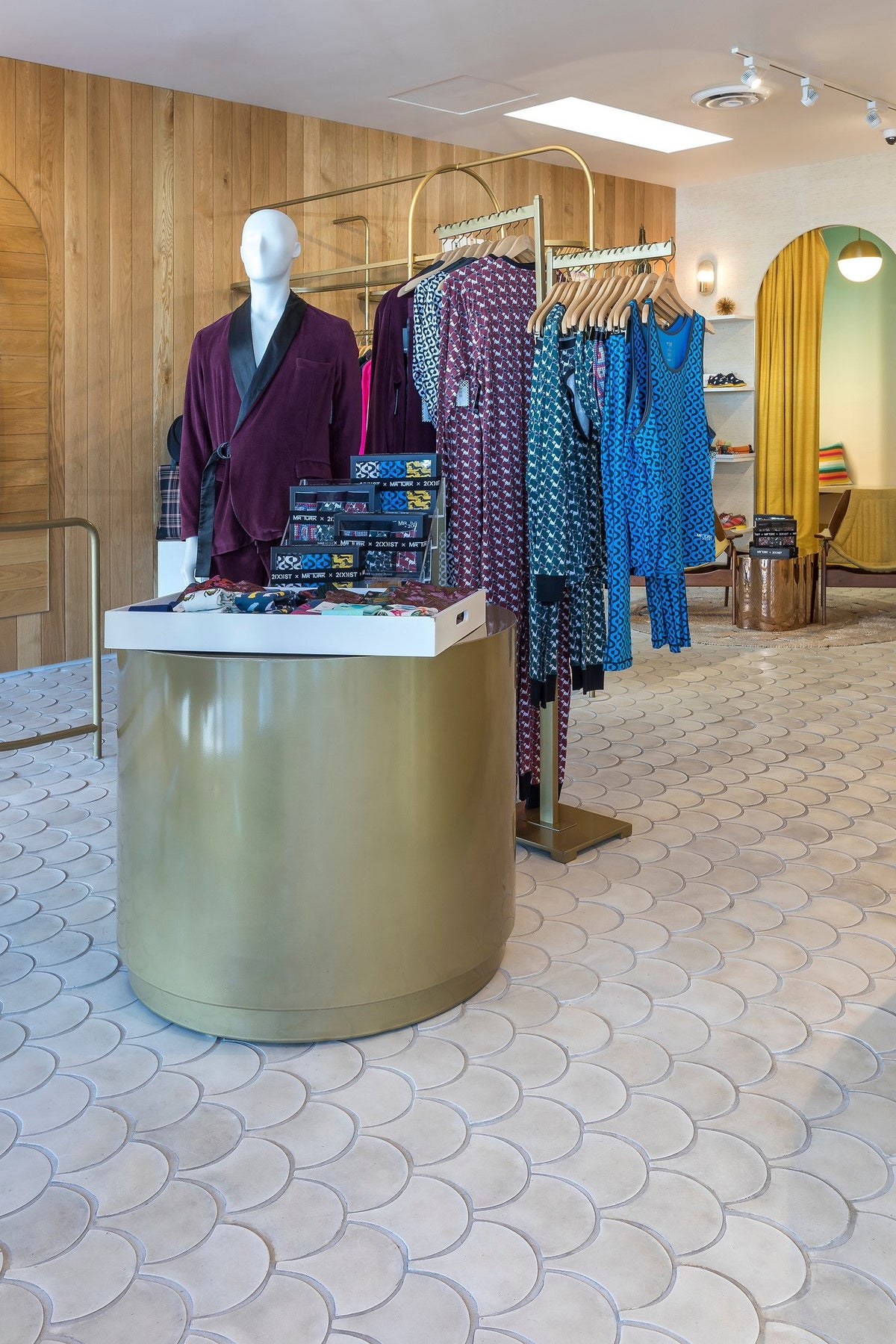 Gold display table on Conche tile