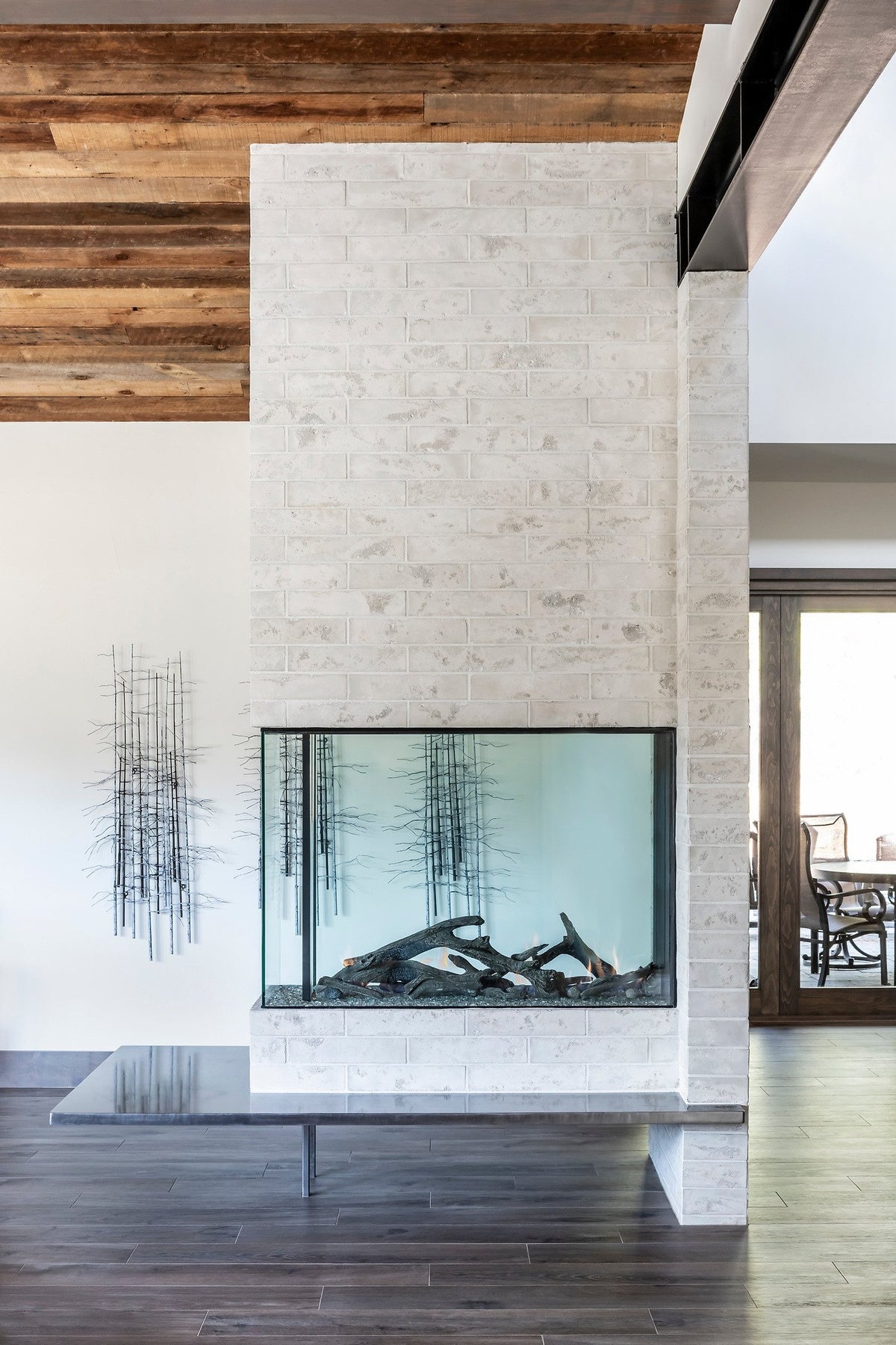 Fireplace column below wood ceiling